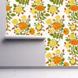 Load image into Gallery viewer, Orange vintage antique Victorian cottage floral fabric peel and stick wallpaper on wall partially rolled up
