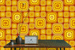 Load image into Gallery viewer, Orange vintage retro bold geometric fabric peel and stick wallpaper with table and clock and vase

