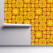Load image into Gallery viewer, Orange vintage retro bold geometric fabric peel and stick wallpaper on wall partially rolled up
