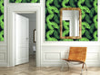 Load image into Gallery viewer, Neon green tropical palm leaves fabric peel and stick wallpaper in room with mirror and chair
