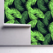 Load image into Gallery viewer, Neon green tropical palm leaves fabric peel and stick wallpaper on wall partially rolled up
