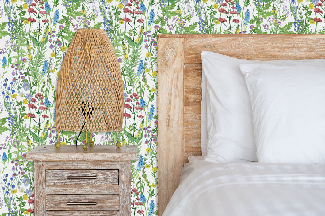 Green and blue wildflower garden cottage fabric peel and stick wallpaper with bed, nightstand and lamp