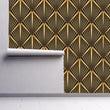 Load image into Gallery viewer, Black and gold vintage geometric Art Deco fabric peel and stick wallpaper on wall partially rolled up
