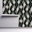Load image into Gallery viewer, Black and grey vintage Art Deco geometric fabric peel and stick wallpaper on wall partially rolled up
