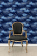 Load image into Gallery viewer, Blue night sky clouds and starts fabric wallpaper with black chair
