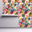 Load image into Gallery viewer, 80s pink and blue tropical retro fabric peel and stick wallpaper on wall partially rolled up
