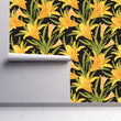 Load image into Gallery viewer, Yellow lily floral botanical fabric peel and stick wallpaper on wall partially rolled up
