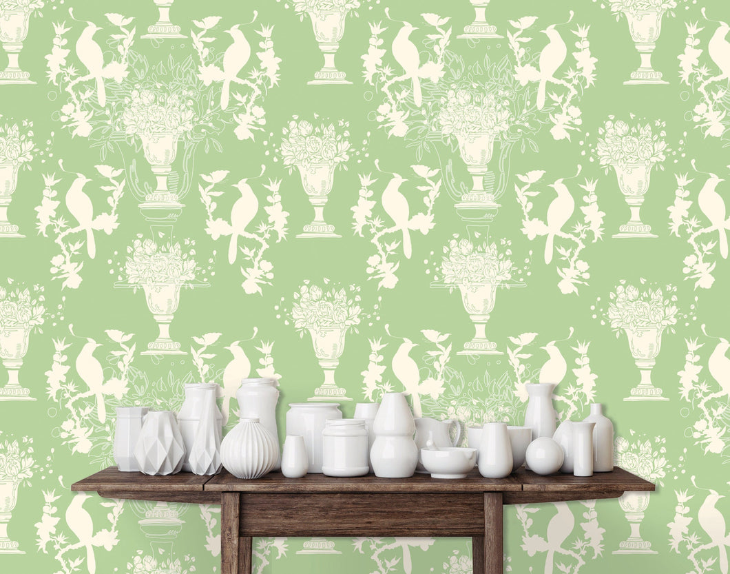 Light green English Chinoiserie botanical fabric peel and stick wallpaper with table and white jars