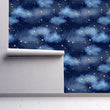 Load image into Gallery viewer, Blue night sky clouds and starts fabric wallpaper on wall partially rolled up
