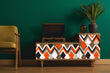 Load image into Gallery viewer, Orange and brown geometric retro Mid-century modern fabric peel and stick wallpaper on vintage radio with plant and chair
