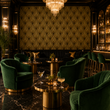 Load image into Gallery viewer, Emerald velvet club chairs surround brass cocktail tables in an elegant Art Deco lounge showcasing the Hutton wallpaper by Pickwick &amp; Elm.

