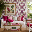 Load image into Gallery viewer, Reese Way wallpaper by Pickwick &amp; Elm in a Palm Beach living room with a white slipcovered sofa, pink velvet pillows, brass coffee table, and tropical artwork.
