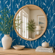 Load image into Gallery viewer, Temple Blue bamboo wallpaper by Pickwick &amp; Elm behind a light oak console with a round wood-framed mirror, ceramic vase, decorative bowl, and coastal accessories.
