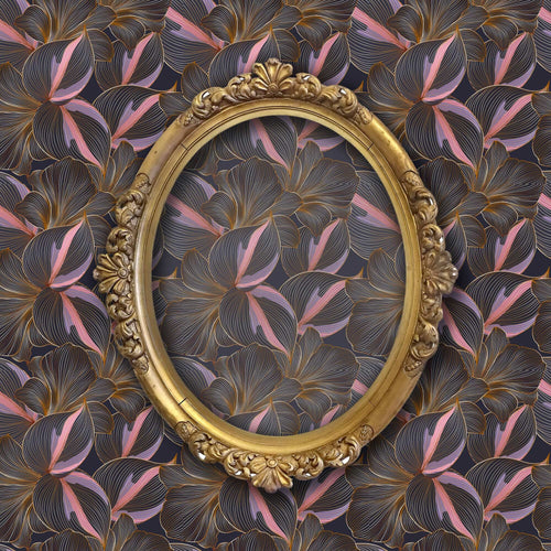 Dark moody tropical leaves fabric peel and stick wallpaper on wall with gold mirror