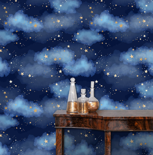 Blue night sky clouds and starts fabric wallpaper with table and gold jars