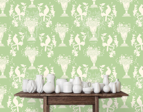Light green English Chinoiserie botanical fabric peel and stick wallpaper with table and white jars